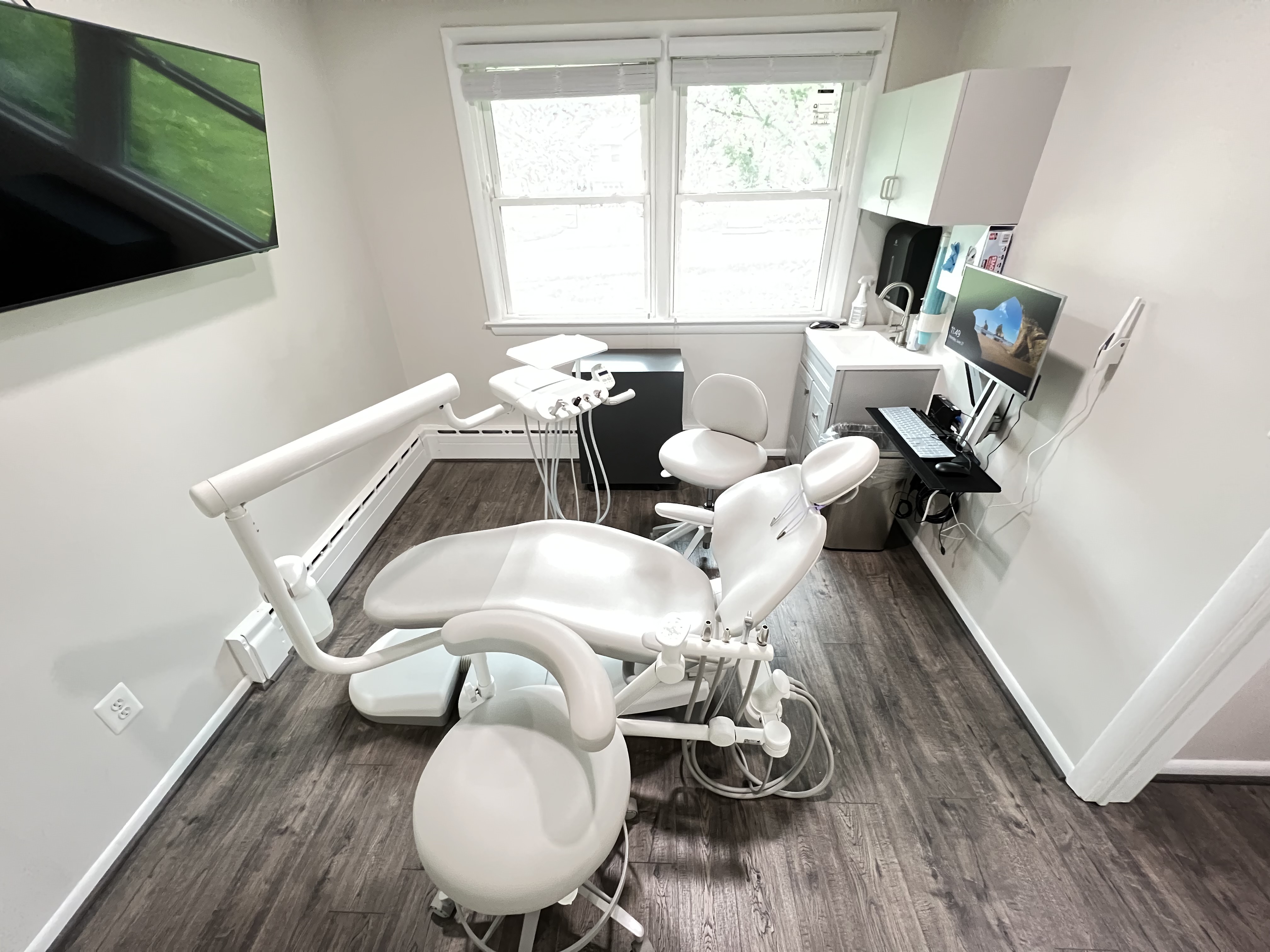 Patient chair in office with TV in Tanager Family Dentistry Office in Columbia, MD